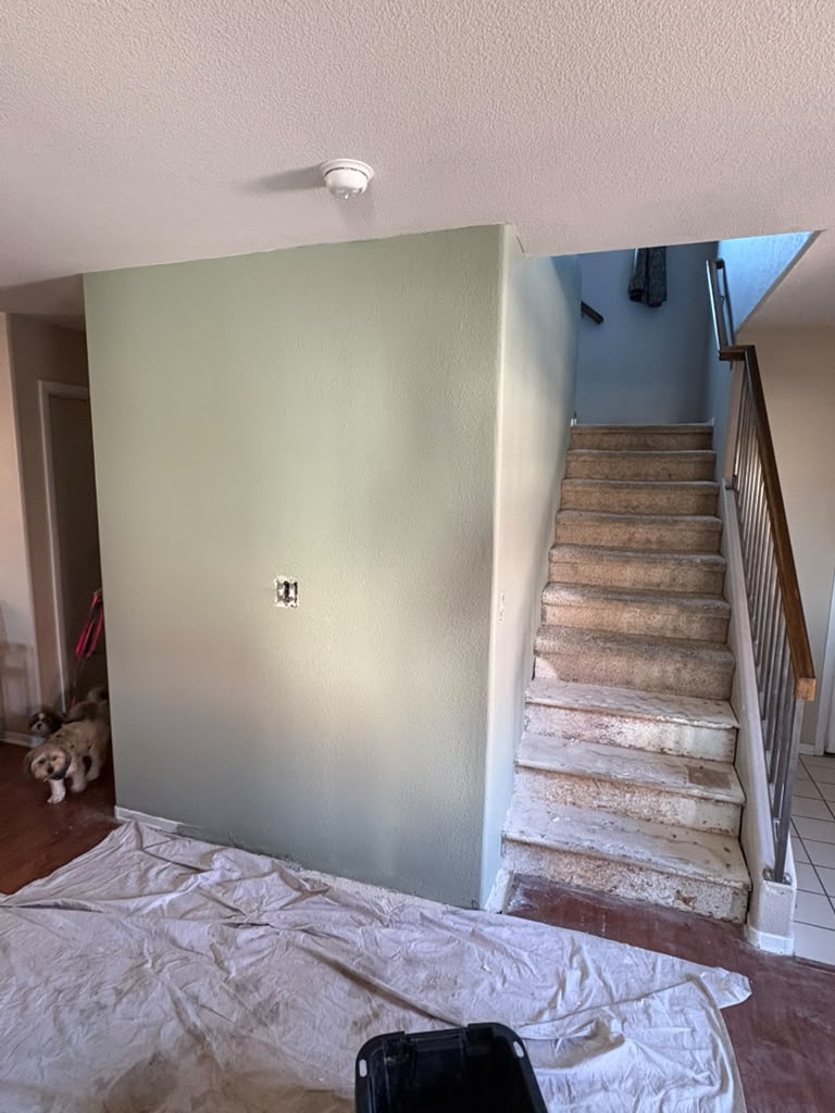 After — stair-side cabinet enclosed in a clean painted wall