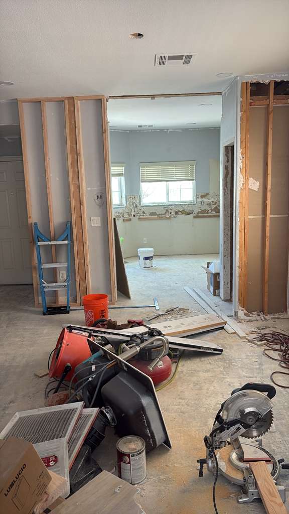 Interior remodel in progress — walls opened to the studs and framing