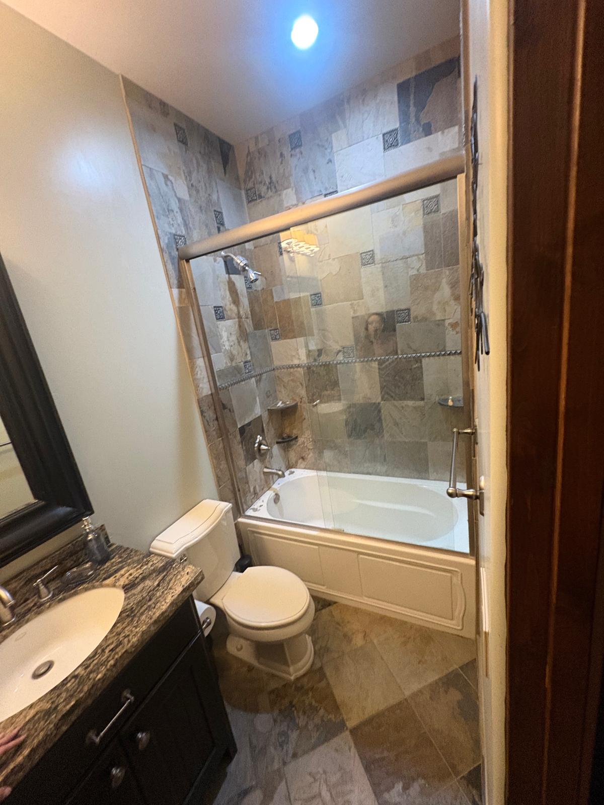 Bathroom before remodel — tile shower and granite vanity in Las Vegas