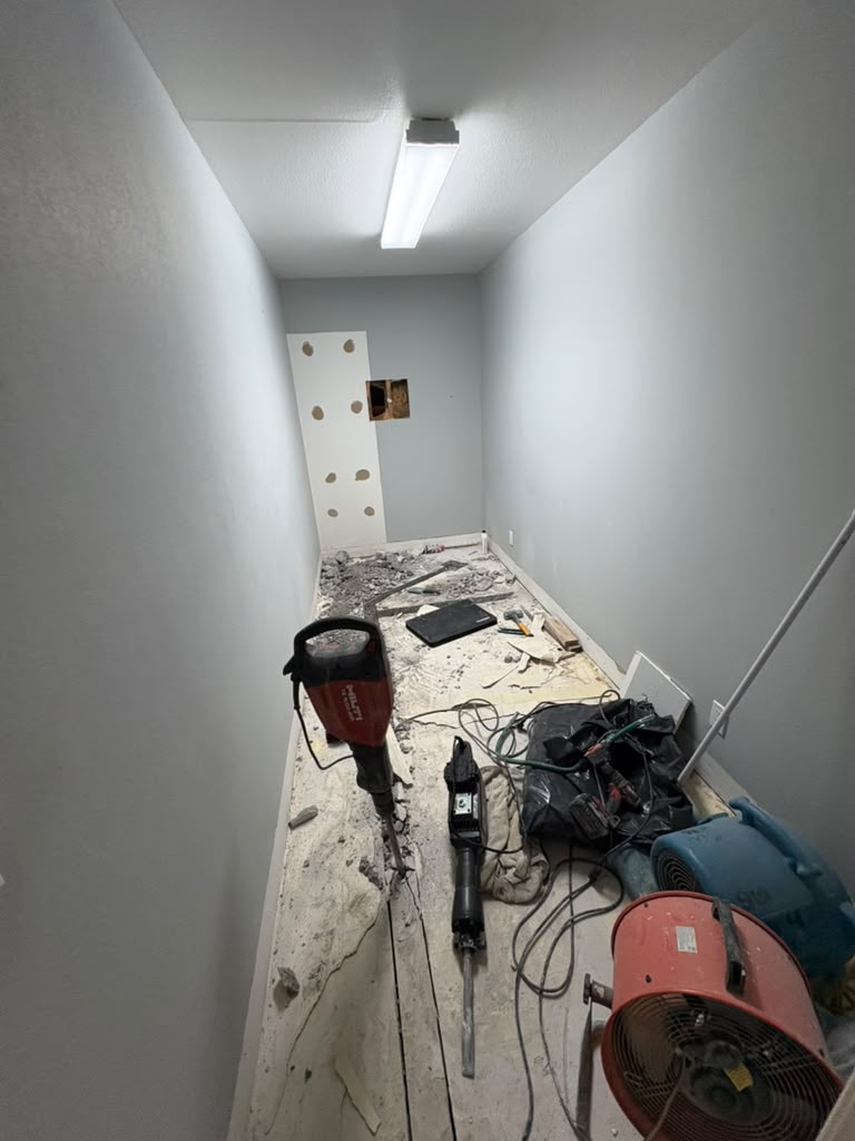 Breaking up a concrete slab to reach under-floor plumbing in Las Vegas