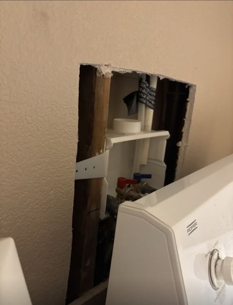 Laundry room water valve access opened in the wall — before, Las Vegas