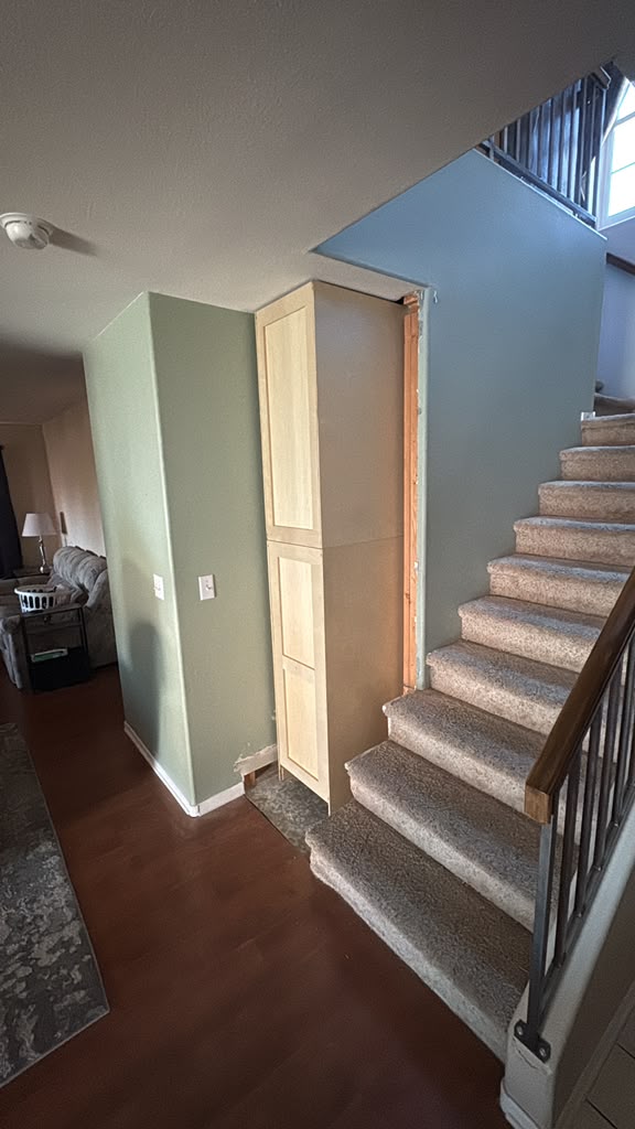 Exposed cabinet beside the staircase before the wall build-out