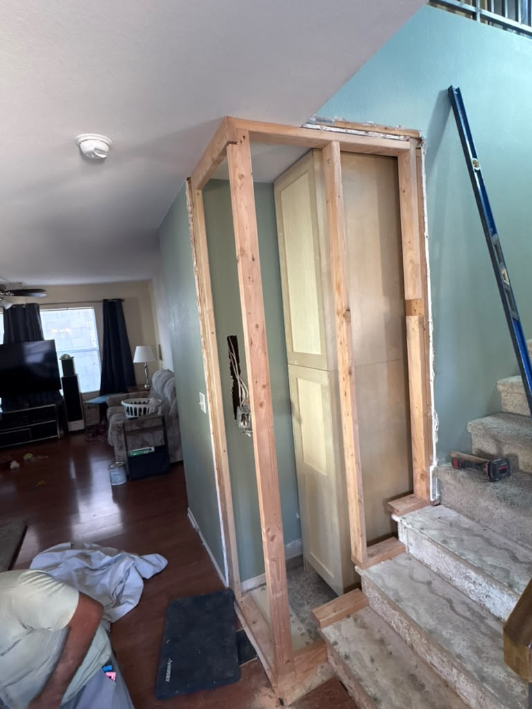 New stud framing built around the stair-side cabinet