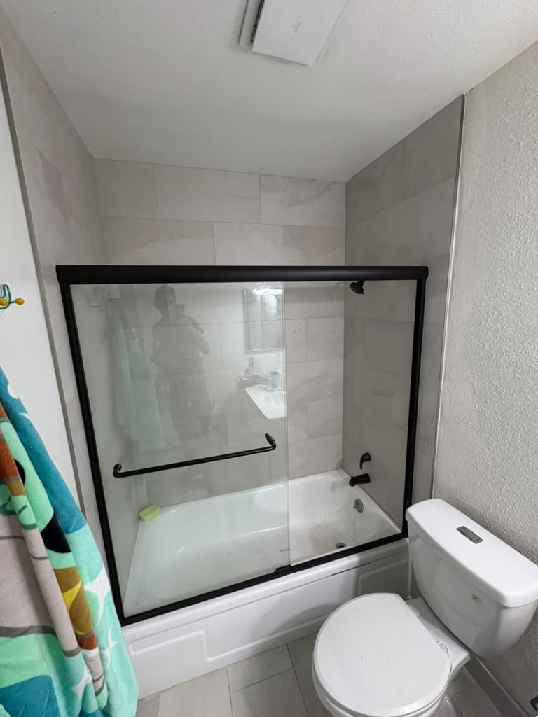 New tub surround tile and sliding glass shower door after a Las Vegas bathroom remodel
